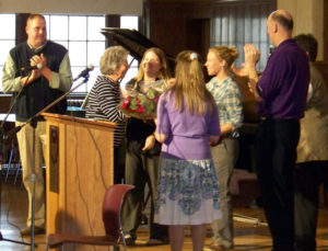 Mrs. Sheren is given flowers by her fellow members of the math department. 